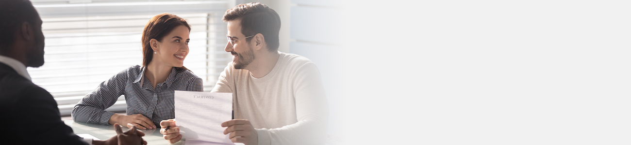 A man and woman are at a table, reviewing a document together